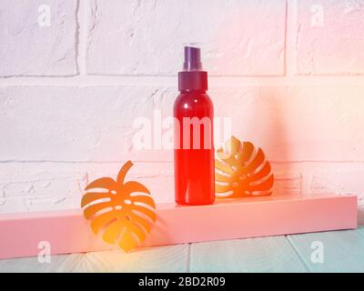 black bottle with sunscreen, antiseptic, sunscreen, empty bottle against a brick wall Foto Stock