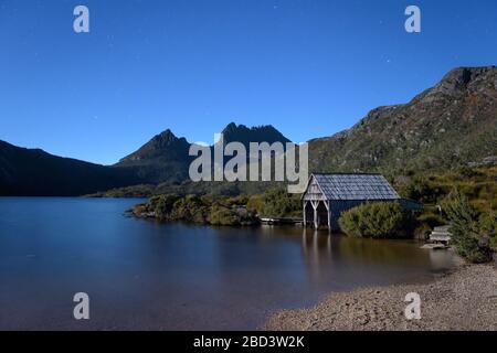 Le stelle blu iniziano a ricoprire l'iconico Lago dove e si stagliano, conducendo alle due vette del Monte Cradle su un cielo notturno limpido in Tasmania. Foto Stock