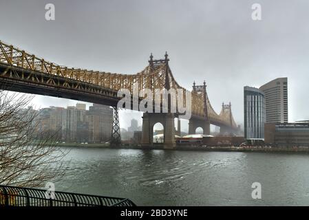 Sutton Place Park a nord in primavera, mentre gli alberi fioriscono con una vista del Queensboro Bridge a New York City. Foto Stock