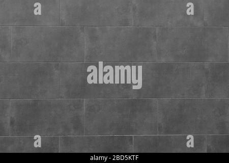 La struttura della parete di mattonelle nere. Sfondo di parete piastrellata nera. Piastrella rettangolare. Foto Stock