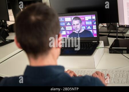 Monaco, Germania. 7 aprile 2020. Un giornalista segue una videoconferenza con il coach Hansi Flick del FC Bayern Monaco su un laptop. Credit: Matthias Balk/dpa/Alamy Live News Foto Stock