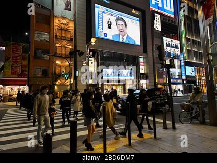 Tokyo, Giappone. 7 aprile 2020. La cartellonistica digitale espone martedì 7 aprile 2020 la conferenza stampa del primo ministro Shinzo Abe, vicino alla stazione di Shinjuku a Tokyo, Giappone. Il primo ministro Shonzo Abe ha detto, vedremo le infezioni picco poi rallentare in due settimane, se facciamo uno sforzo e ridurre le nostre interazioni con gli altri di almeno il 70 - 80 per cento, in linea di principio. Foto di Keizo Mori/UPI Credit: UPI/Alamy Live News Foto Stock