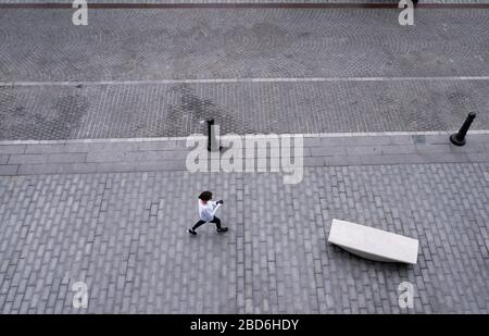 Washington DC, Stati Uniti. 7 aprile 2020. Una donna cammina su una strada vuota durante la pandemia di Coronavirus al Wharf a Washington, DC il martedì 7 aprile 2020. Foto di Kevin Dietsch/UPI Credit: UPI/Alamy Live News Foto Stock