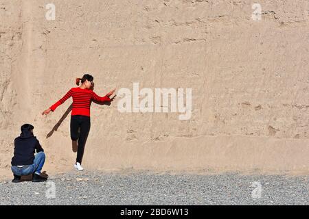 Foto in Passo Jiayu: Modello vestito nero-rosso contro il muro-Jiayuguan-Gansu-Cina-0780 Foto Stock