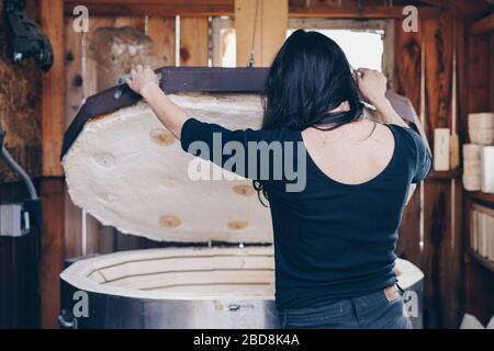 artista attende corpo pezzo di vetro infuso fusione da fuori del forno Foto Stock