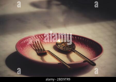 Un piatto vuoto in un ristorante chiuso mostra la solitudine, la crisi economica, la fame e la depressione come conseguenza di divaricarsi, bloccare e sé Foto Stock