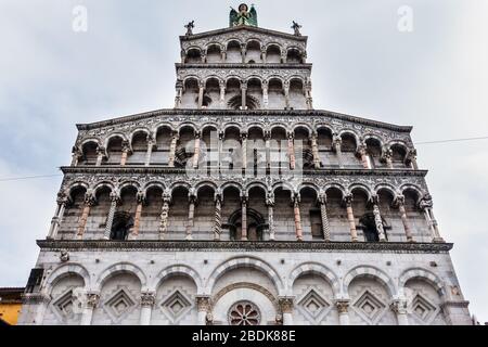 Facciata della chiesa di San Michele in Foro a Lucca, finemente decorata con statue e sculture, Toscana, Italia Foto Stock