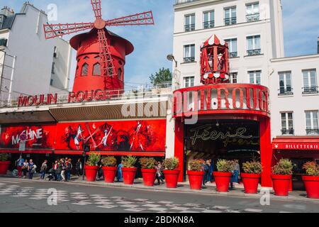Cabaret parigino Moulin Rouge . Torre rossa, le ali del mulino e l'iscrizione Moulin Rouge . Nelle vicinanze - una torretta pittoresca con un'iscrizione di bar Foto Stock