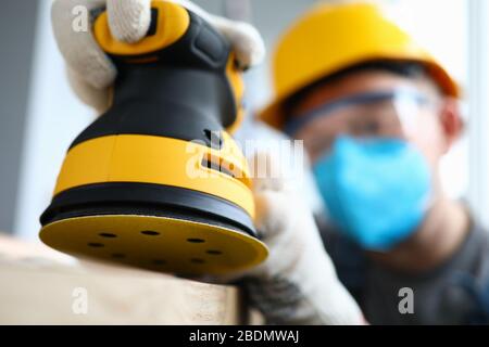 Uomo in guanti che lavora alla ristrutturazione Foto Stock