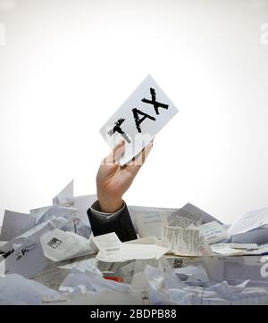 Concept business image of an arm coming out of a pile of receipts and paperwork holding an envelope with tax printed onto it due to Covid-19. Foto Stock