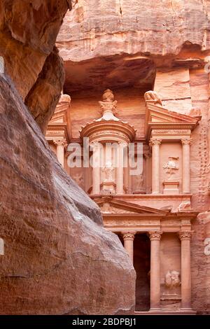 I primi scorci dell'antico Tesoro, el-Khazneh, dalla foce della gola al-Siq, Petra, Giordania. La città di Petra è stata perduta per oltre 1000 anni Foto Stock