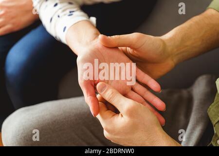 Palmist professionale che tiene la mano dei suoi clienti femminili Foto Stock