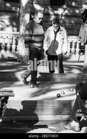 Due uomini che giocano e guardano la bocce sulla Promenade Passeig de Lluís Companys, Barcellona, Spagna. Foto Stock