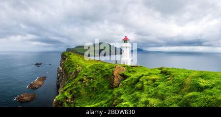 Vista panoramica sul vecchio faro sull'isola di Mykines, isole Faroe, Danimarca. Fotografia di paesaggio Foto Stock