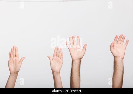 Immagine di primo piano delle mani sollevate di un uomo e di una donna isolata su sfondo bianco della parete. Foto Stock