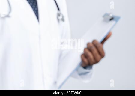 Primo piano della cartella medica in mani di medico africano Foto Stock