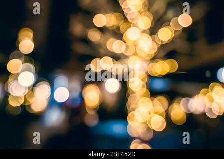 Bokeh di luci festive calde intorno agli alberi durante la stagione di Natale, Londra Regno Unito Foto Stock