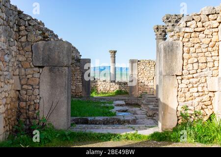 Colonna alla fine di un passaggio pedonale presso le rovine romane di Volubilis in Marocco Foto Stock