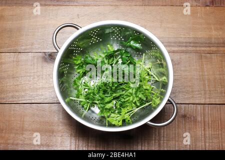 Prezzemolo in Coriander su sfondo di legno Foto Stock