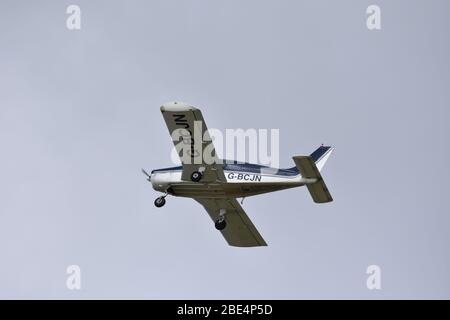 Un Piper PA28-140 Cherokee motore singolo, quattro posti, aereo leggero nel cielo sopra Bristol Airport, G BCJN Foto Stock