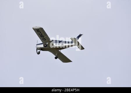 Un Piper PA28-140 Cherokee motore singolo, quattro posti, aereo leggero nel cielo sopra Bristol Airport, G BCJN Foto Stock