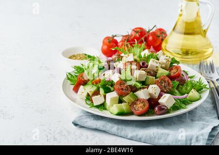 Insalata greca con feta e pomodori, cibo da dieting su sfondo bianco copia spazio primo piano Foto Stock