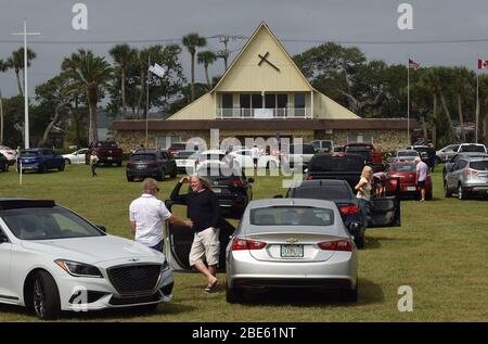 12 aprile 2020 - Daytona Beach Shores, Florida, Stati Uniti - persone in auto assistere Pasqua Domenica servizi presso la Daytona Beach Drive-in Christian Church come un modo per praticare le distanze sociali durante la pandemia di coronavirus il 12 aprile 2020 a Daytona Beach Shores, Florida. L'ordine di soggiorno a casa della Florida esenta i servizi religiosi, ma il governatore Ron DeSantis ha consigliato di non partecipare a riunioni religiose affollate. (Paul Hennessy/Alamy) Foto Stock