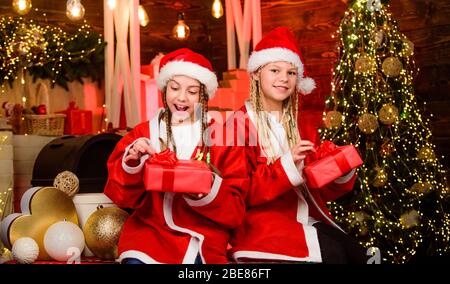 Servizio di consegna. Ragazze amici sorelle babbo natale costumi di consegna regali. Festa di Santa. Felice anno nuovo. I bambini si divertono la vigilia di natale. Maschera invernale. Felicità e gioia. Equipaggio di Santa. Foto Stock