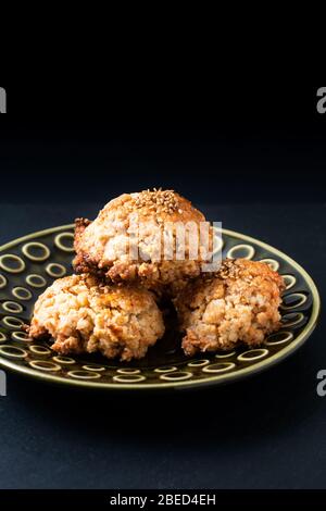 Cucina orientale concetto casalinga cinese Sesame cookie in piastra di ceramica verde su bordo di pietra ardesia nera con spazio copia Foto Stock