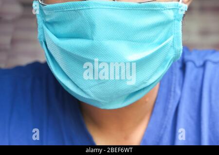 Uomo che indossa una maschera igienica per prevenire le infezioni Foto Stock