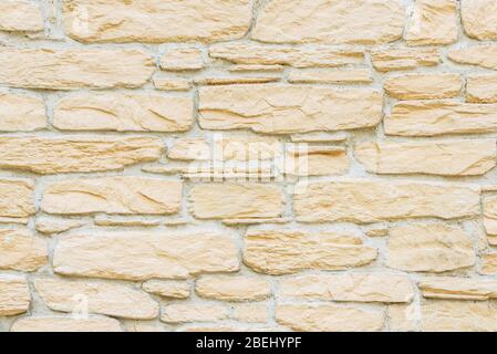 Marmo mattone pietra mattone parete texture sfondo in colore beige chiaro giallo crema Foto Stock