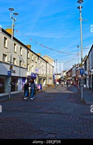 Una vista dei negozi lungo Adare Street, una delle principali aree dello shopping di Bridgend. Foto Stock