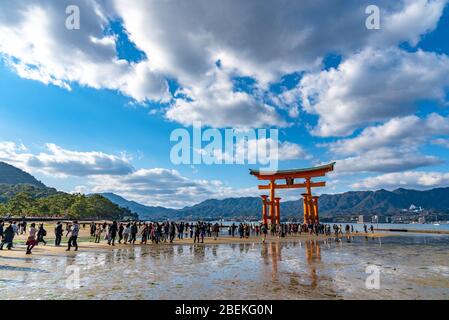 Galleggianti rosso gigante porta Grand o-Torii si trova nella baia di Miyajima spiaggia a bassa marea in giorno di sole. Capodanno nel Santuario di Itsukushima Foto Stock