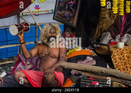 naga sadhu suonando daaru uno strumento musicale di shiva al campo di transito kolkata bengala ovest india Foto Stock