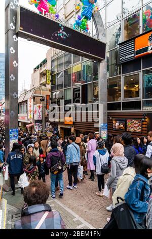 Takeshita Street entrata a Harajuku di Tokyo. Vista lungo egli famosa strada pedonale dello shopping affollate di giapponese e i turisti stranieri. Ore diurne. Foto Stock