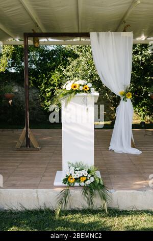 Arco nuziale. Matrimonio rustico. Area per matrimoni coperta di fiori. Foto Stock