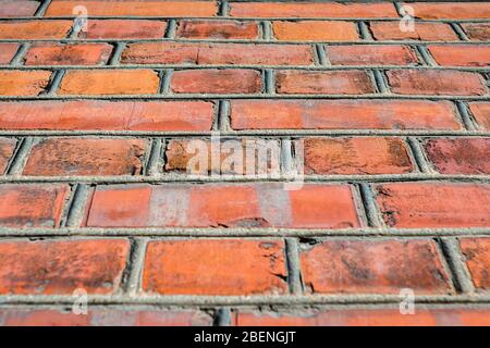 vista dettagliata da vicino su pareti di mattoni rossi in edifici vecchi e stagiati, struttura di pareti di mattoni rossi, prospettiva dal basso verso l'alto Foto Stock