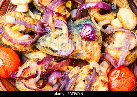 Sgombro fritto con verdure alla griglia su un piatto. Pesce arrosto Foto Stock