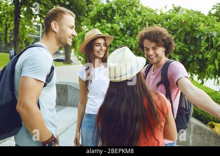 Gli studenti allegri sorridono a un incontro di riunione in un parco cittadino Foto Stock