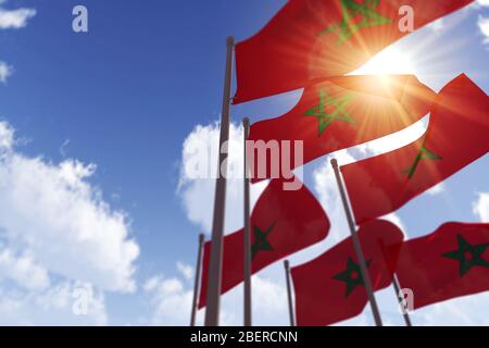 Le bandiere del Marocco sventolano contro un cielo blu. Rendering 3D Foto Stock