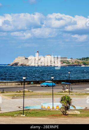 Vista su El Malecon verso il Castello e il Faro di El Morro, l'Avana, la provincia di la Habana, Cuba Foto Stock