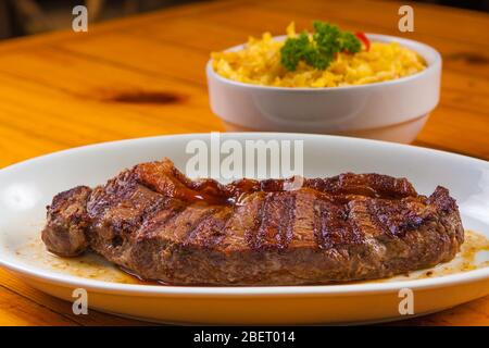 Tradizionale Picanha brasiliano con riso allo zafferano ed erbe Foto Stock