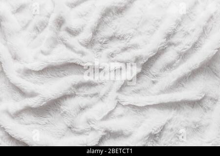 Astratto orizzontale bianco texture lana sfondo. Pelle di pelliccia di agnello rugosa, tappeto Foto Stock