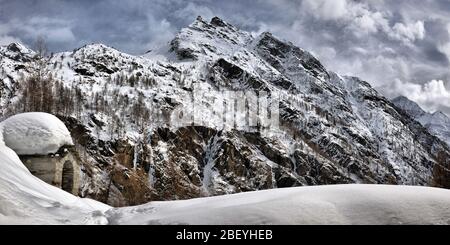 Tetto di uno chalet cowred con neve. Case Alpine sotto la neve Foto Stock