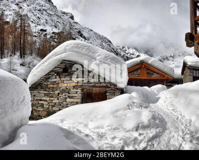 Tetto di uno chalet cowred con neve. Case Alpine sotto la neve Foto Stock