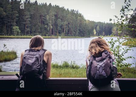 Turisti sul molo di legno sul lago Suchar Wielki nella zona del Parco Nazionale di Wigry vicino al villaggio di Slupie, Voivodato di Podlaskie in Polonia Foto Stock