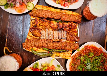 Stile turco Adana Kebab. Tradizionale turco alimentare Adana Kebab su tavola di legno. Foto Stock
