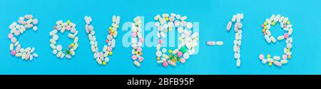 iscrizione covid-19 da lettere fatte di pillole su sfondo blu. corona virus. covid, ncov concetto