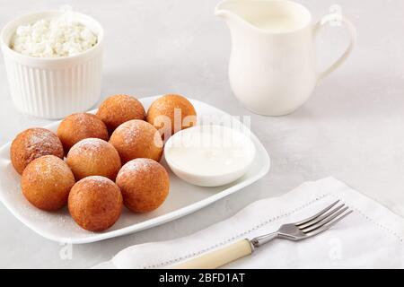 La colazione era ottima. Palline di ciambelle di formaggio cottage su uno sfondo chiaro. Foto Stock