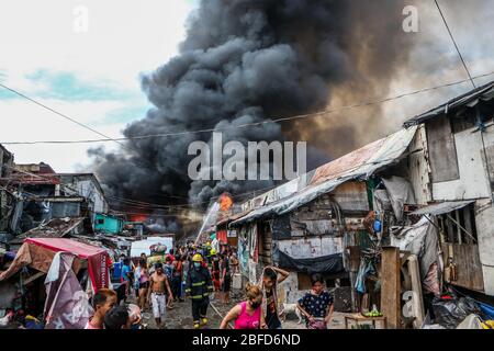 Manila, Filippine. 18 Aprile 2020. I residenti sono evacuati da un incendio che inghiotte una zona di baraccopoli a Manila, nelle Filippine, 18 aprile 2020. Centinaia di famiglie qui sono state sfollate sabato a causa del fuoco. Credit: Rouelle Umali/Xinhua/Alamy Live News Foto Stock